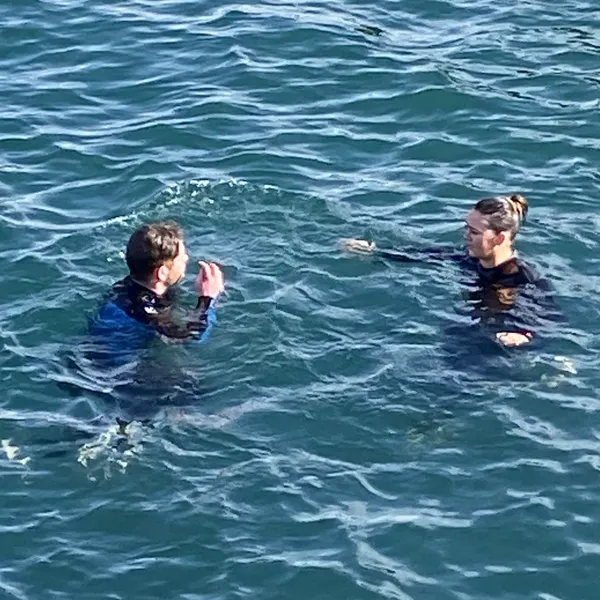 A man and a woman peacefully floating in sea